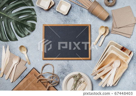 Eco craft paper and bamboo tableware. Recycling or eco-friendly Paper cups, dishes, platesand, wooden cutlery, monstera leaves, mock up, Top view, Copy space Eco craft paper and bamboo tableware. Recycling or eco-friendly Paper cups, dishes, platesand, wooden cutlery, monstera leaves, mock up, Top view, Copy space 67448403