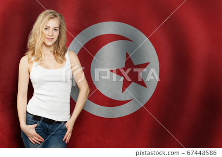 Portrait of happy blonde gitl on Tunisia flag 67448586