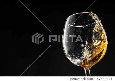 Glass of wine on black background, close up Glass of wine on black background, close up 67448741