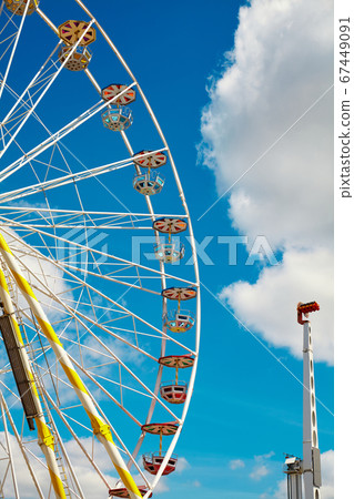 Ferris wheel on a sunny day with blue sky 67449091
