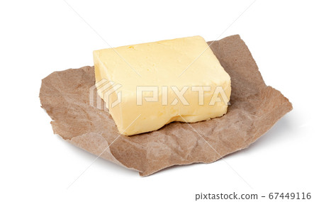 Fresh butter on craft paper isolated on white background Fresh butter on craft paper isolated on white background 67449116