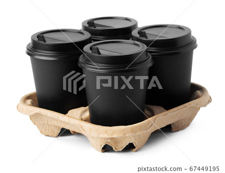Four takeaway coffee cups in a tray isolated on white 67449195