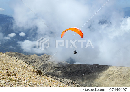 paraglider taking off from the mountain 67449497