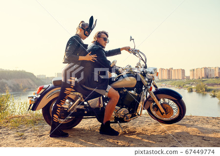Sexy couple of bikers on the vintage custom motorcycle, girl in a rabbit mask 67449774