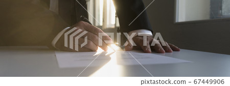 Panorama view of businessman in a shadowy office Panorama view of businessman in a shadowy office 67449906