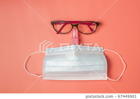 Creative flat lay concept with glasses, bottle of sanitizer and medical mask. Self protection concept Creative flat lay concept with glasses, bottle of sanitizer and medical mask. Self protection concept 67449981