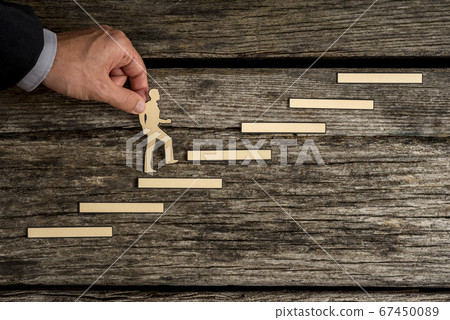 Businessman climbing the steps to success 67450089