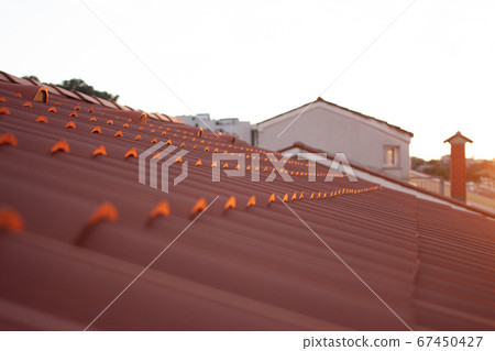 sunset over closeup red tile roof sunset over closeup red tile roof 67450427