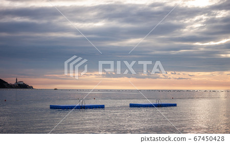 cloudy sunset over adriatic sea surface 67450428