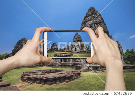 Girl taking pictures on mobile smart phone in 67452659