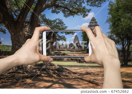 Girl taking pictures on mobile smart phone in 67452662