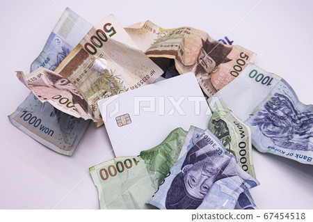 Credit card in the center of a crumpled bill Credit card in the center of a crumpled bill 67454518