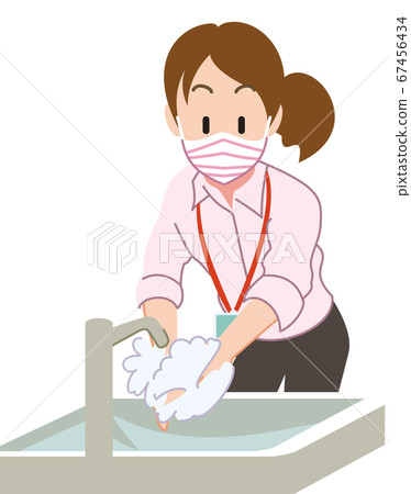 Female employee wearing a mask and washing hands 67456434