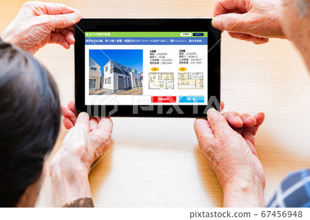 Old couple tablet housing information site 67456948