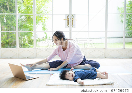 Parents and children doing online yoga at home 67456975