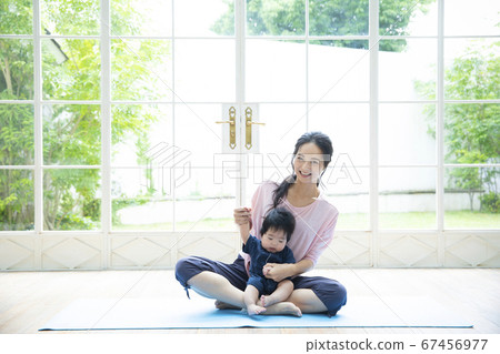 Parents and children doing yoga at home 67456977