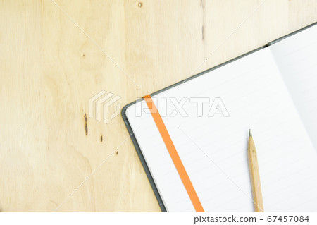brown pencil with notebook on work space wooden. brown pencil with notebook on work space wooden. 67457084