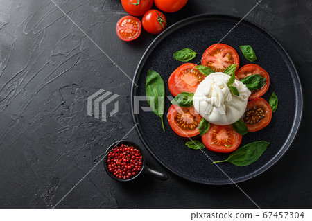 Burrata, Italian fresh cheese made from cream and Burrata, Italian fresh cheese made from cream and 67457304