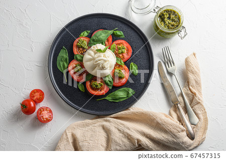 Salad with traditional italian burrata cheese made Salad with traditional italian burrata cheese made 67457315