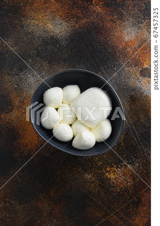 Mozzarella cheese balls in black bowl different 67457325