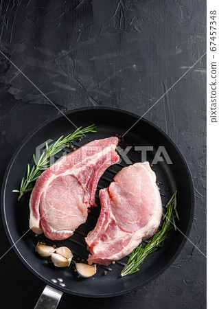 pork rib chops in frying pan grill skillet with 67457348