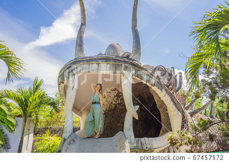 Woman tourist in Chua Tu Van temple made of shells and corals or the dragon maze. Travel to Vietnam Concept 67457572