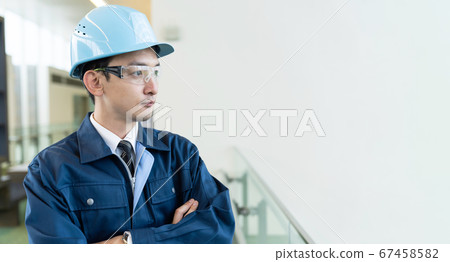 Male engineer looking into the distance 67458582