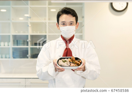 Male cook with lunch, home meal delivery takeout Male cook with lunch, home meal delivery takeout 67458586