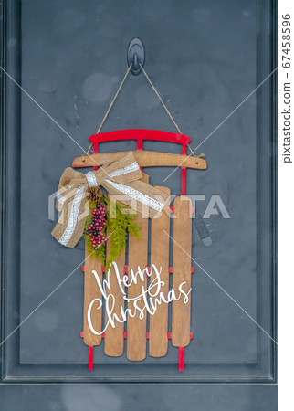 A holiday entryway with christmas door decoration 67458596