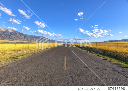 Highway along mountain under brilliant sky in Utah 67458598