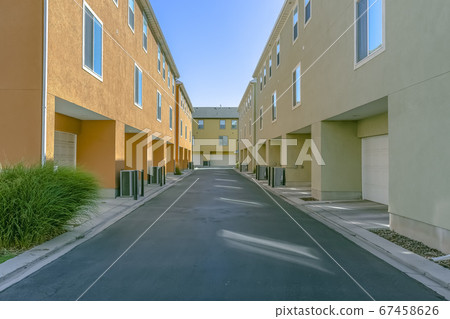 Garage doors at the back of residential buildings 67458626