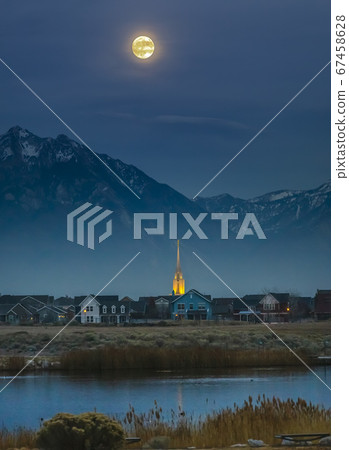 Full moon over homes lake and mountain in Daybreak Full moon over homes lake and mountain in Daybreak 67458628