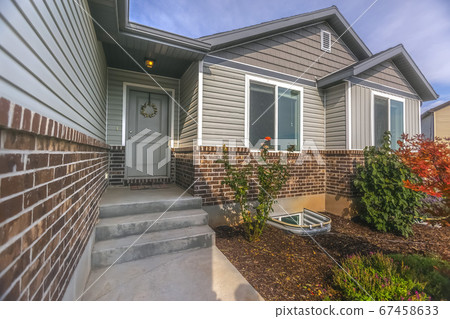 Front of home with garden against sky with clouds Front of home with garden against sky with clouds 67458633