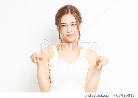 Young woman showing point with forefinger Young woman showing point with forefinger 67459018