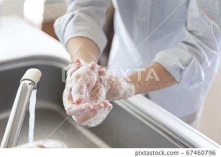 Hand of senior doing hand washing 67460796