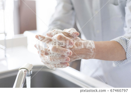 Hand of senior doing hand washing 67460797