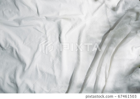 A white cloth reflecting natural light and shadows of leaves A white cloth reflecting natural light and shadows of leaves 67461503