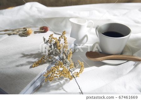 Windowsill with white cloth and coffee cup 67461669