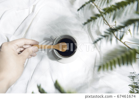 Windowsill with white cloth and coffee cup 67461674