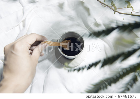 Windowsill with white cloth and coffee cup 67461675