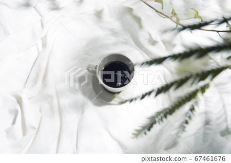 Windowsill with white cloth and coffee cup 67461676