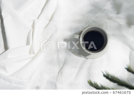 Windowsill with white cloth and coffee cup 67461678