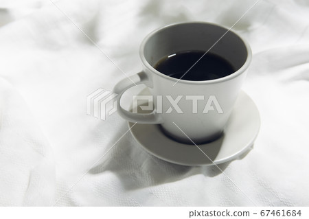 Windowsill with white cloth and coffee cup 67461684