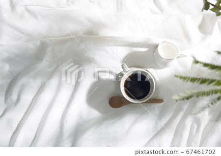 Windowsill with white cloth and coffee cup 67461702