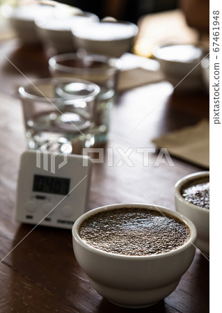 coffee grounds in cup on table preparing for professional Q Grader to test and inspect quality. coffee grounds in cup on table preparing for professional Q Grader to test and inspect quality. 67461948