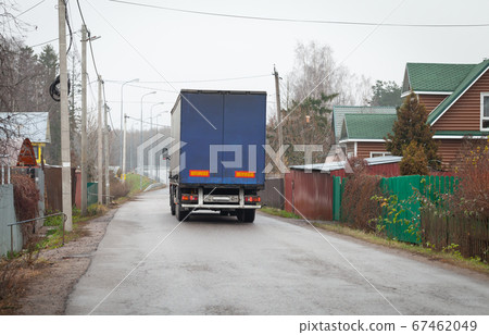 Lorry goes on empty rural road at day Lorry goes on empty rural road at day 67462049