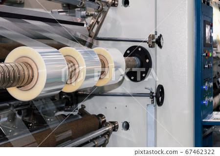 roll of plastic packaging film on the automatic packing machine in food product factory. industrial and technology concept. 67462322