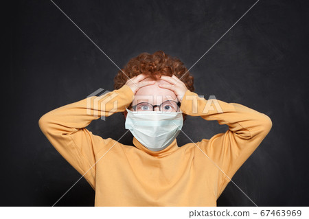 Shocked child in medical protective face mask  67463969