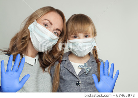 Mother and daughter in medical protective face 67463978