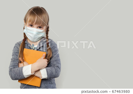 Happy child girl wearing medical protective face 67463980